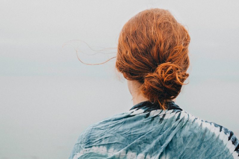 a woman with ginger hair which is in a bun from behind