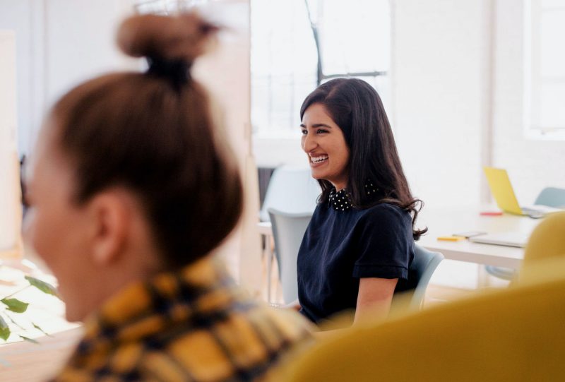 a woman smiling in an office setting