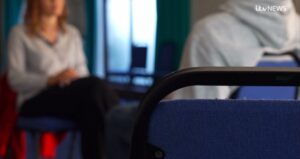 silhouette of ex-service user facing an interviewing journalist.