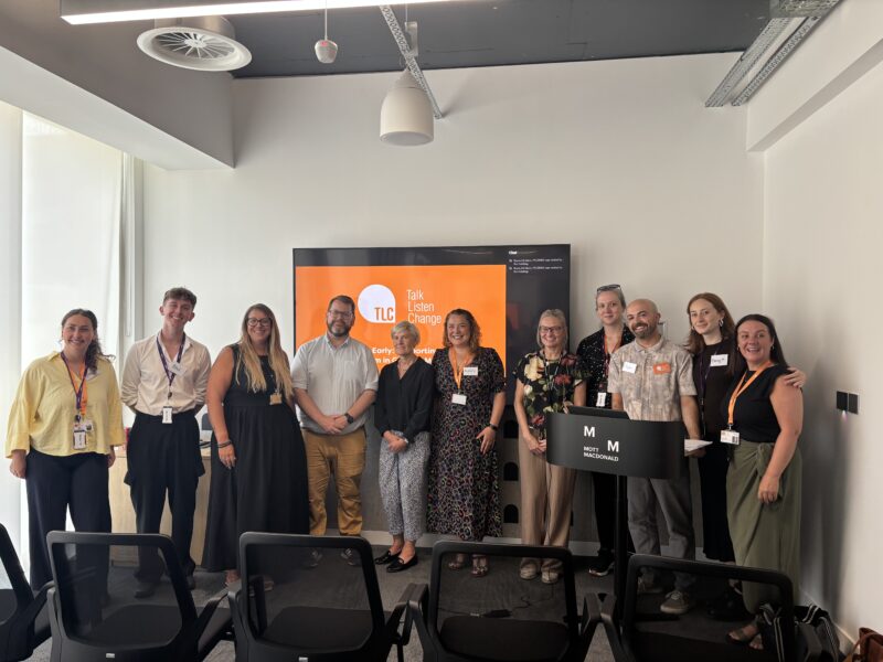 An event littered with TLC colleagues. The presentation in the background shows the TLC logo.