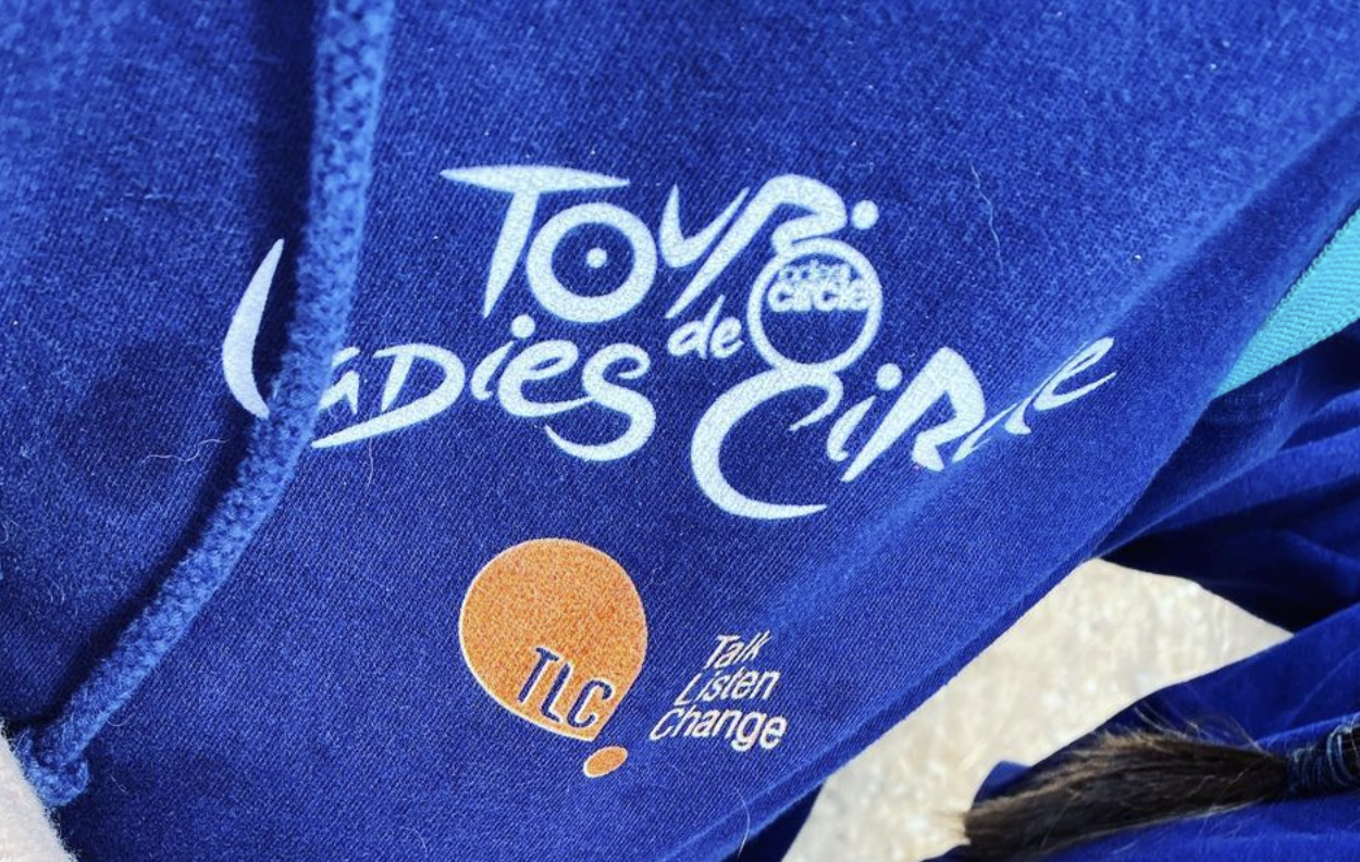 3 people bring blue hoodies into the shot, emphasising the charity logos on them