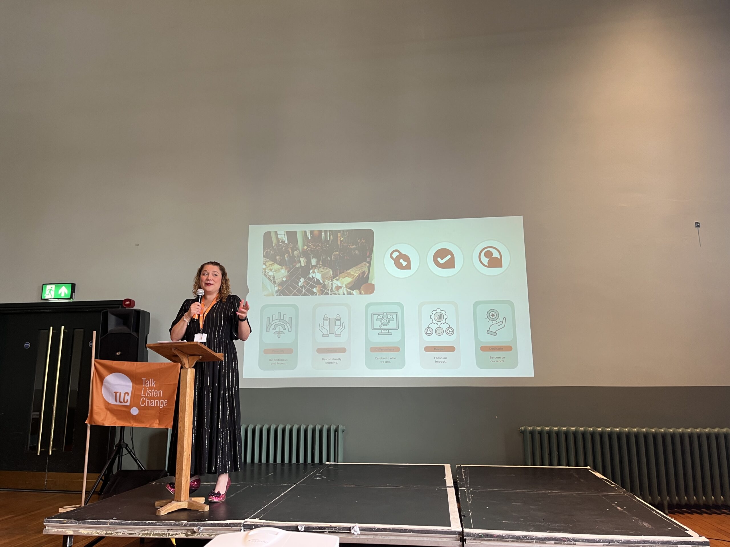 An image of Michelle Hill the eco presenting on stage