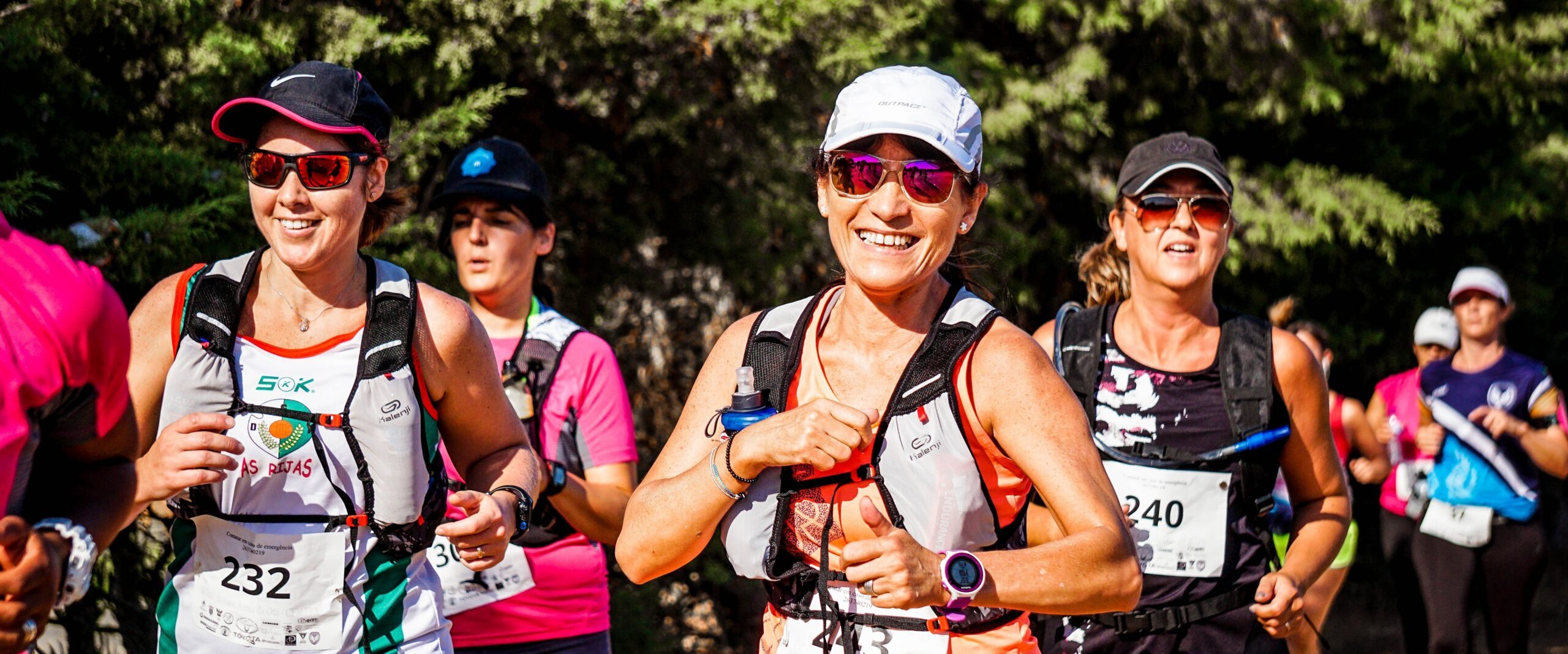 female runner in the forefront of a race.
